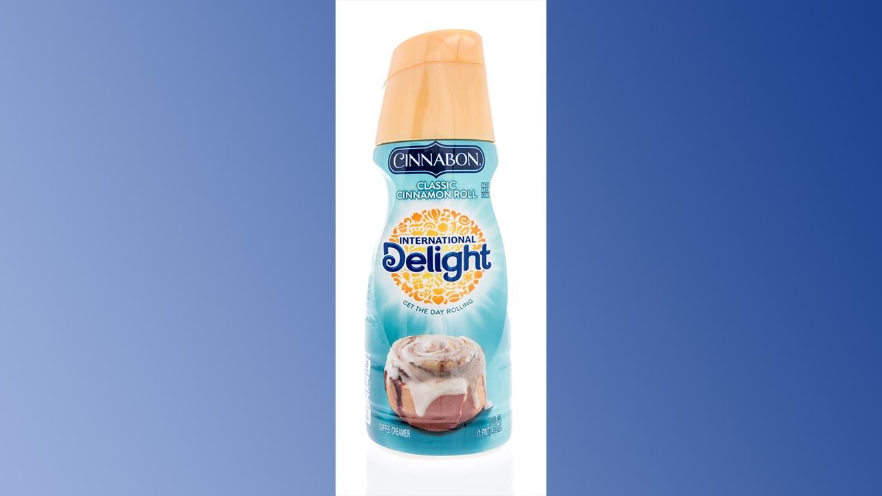 Bottle of coffee creamer on a blue background.